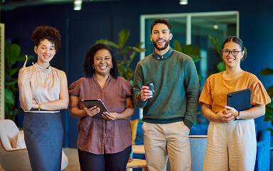 A group of adults at a school smiling.